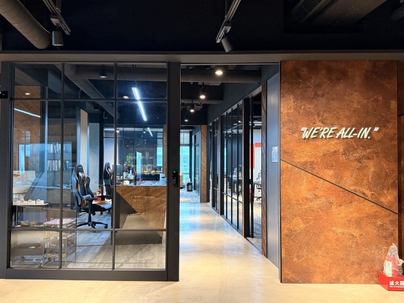 Office entrance with WE'RE ALL-IN. on the wall